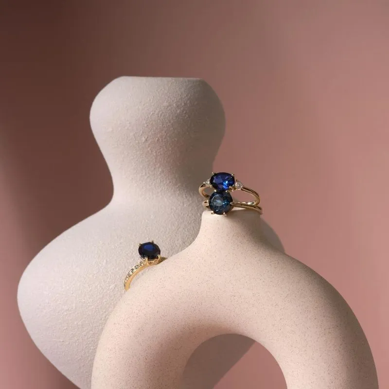 gold plated closed ring with dark blue cz 8mm facet